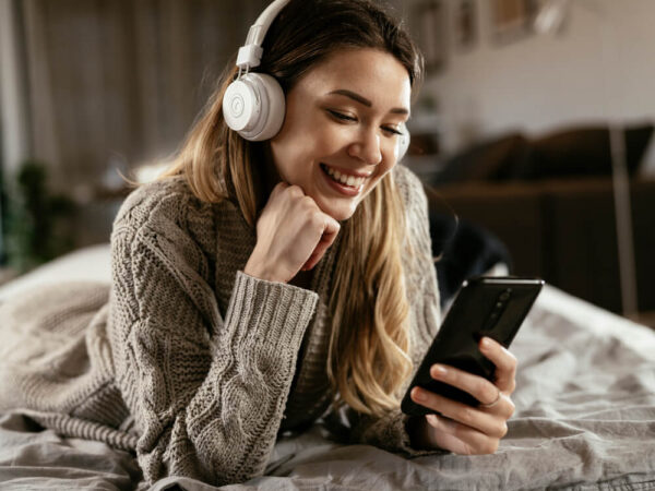 Woman listening to audio while browsing on mobile device